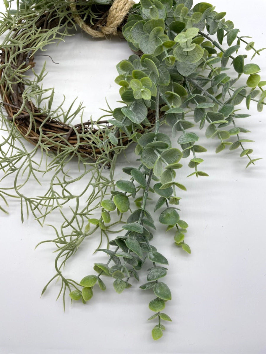 lush handmade eucalyptus wreath with greenery on grapevine base finished with rope to hang wreath on wall or door