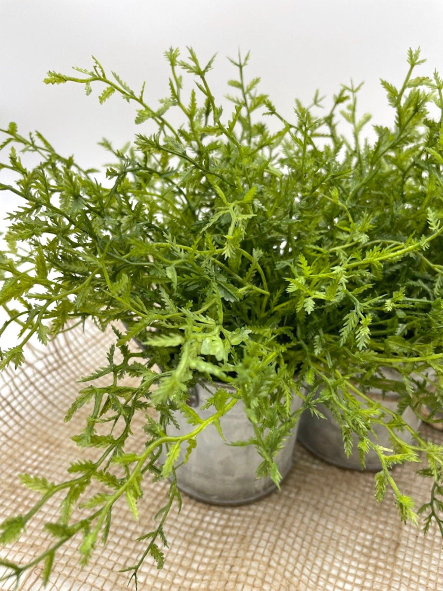close up for faux plantfern like in vivid green set in triple can galvanized metal planter with handles