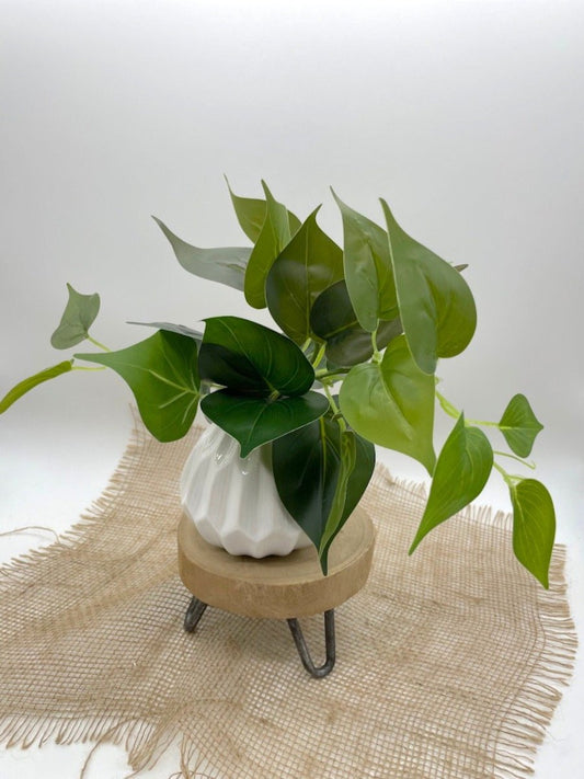 realistic looking vivid green Fake Plants in White Ceramic Vase
