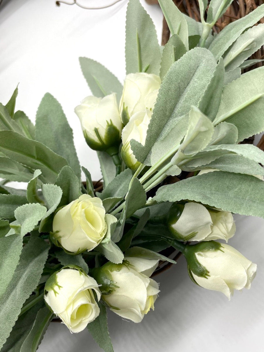 close up for faux sage wreath with ivory roses on grapevine base