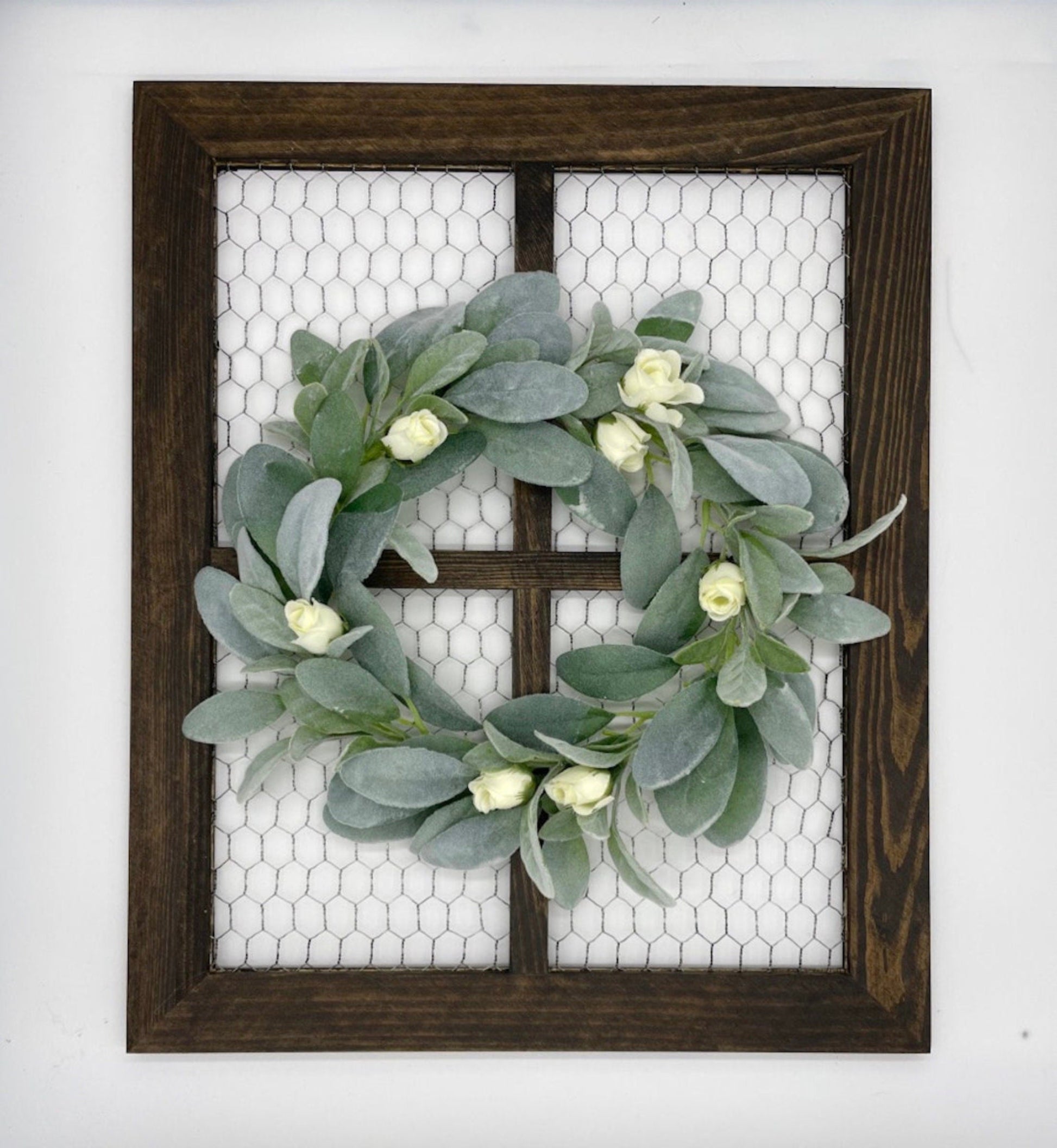 wooden window frame with chicken wire and decorated with lambs ear wreath