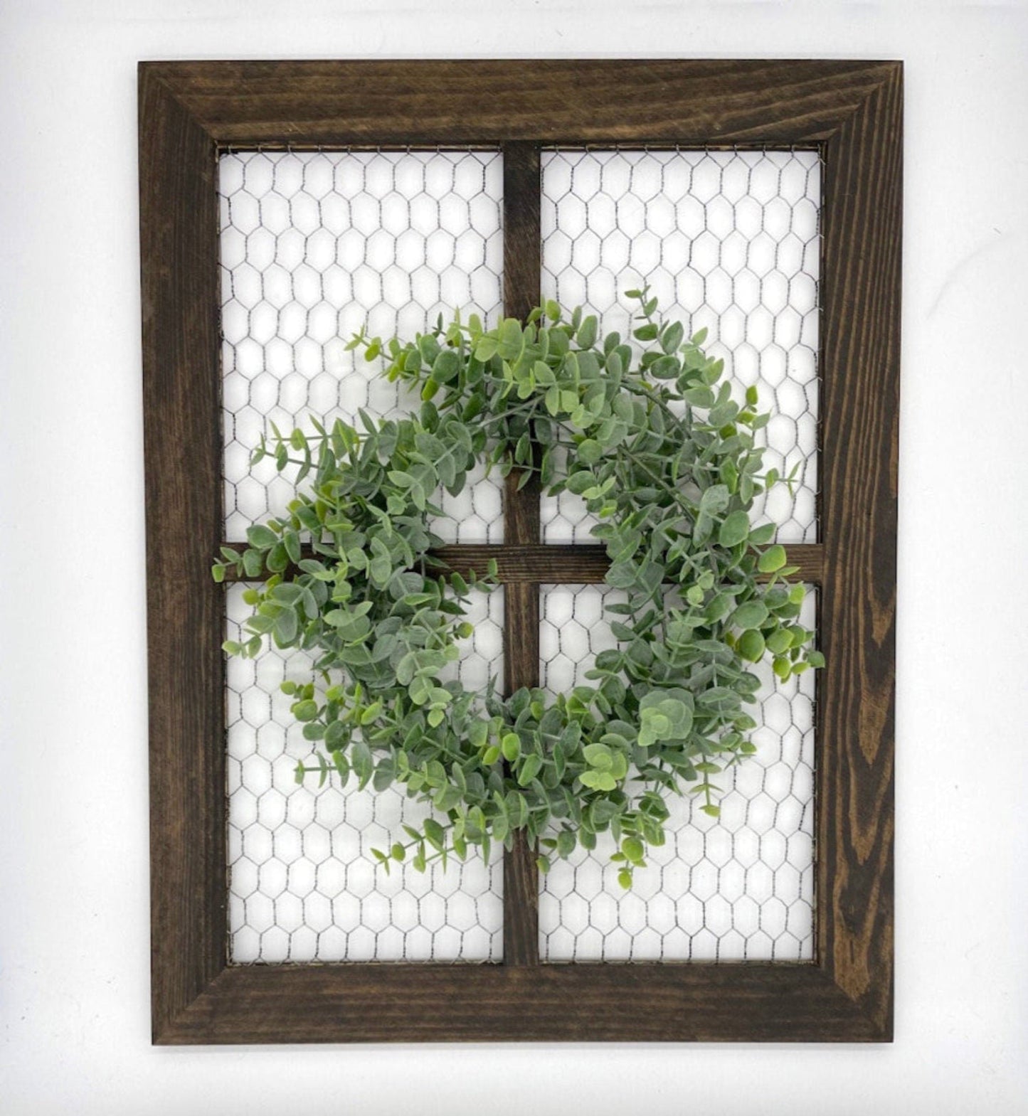 window frame with chicken wire decorated with realistic green eucalyptus wreath