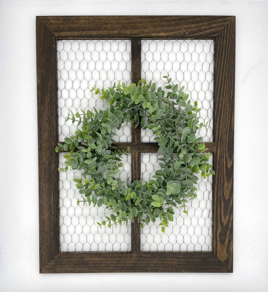 window frame with chicken wire decorated with realistic green eucalyptus wreath
