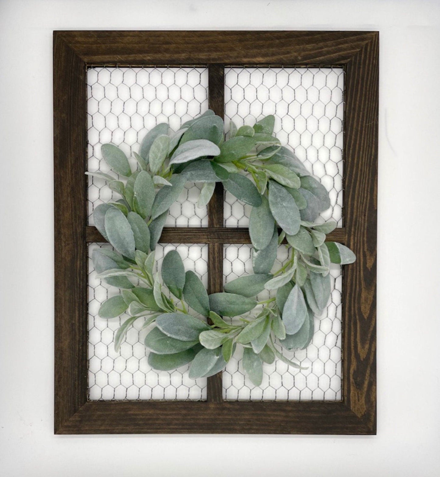 wooden window frame with chicken wire and decorated with lambs ear wreath